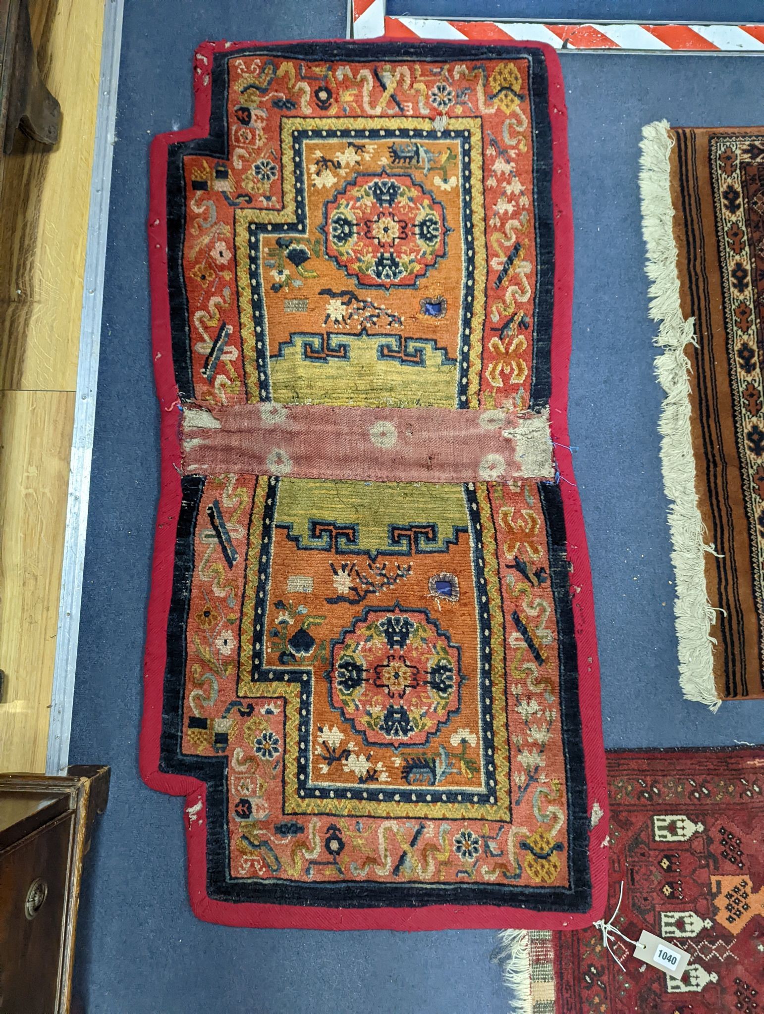 An antique Tibetan saddle cover, 132 x 64cm
